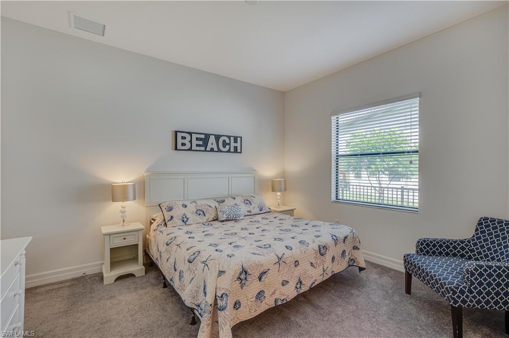 4549 Azalea Drive Naples, FL 34119 - Photo 19 of 25 a bedroom with a bed and a couch