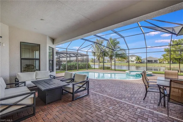 a view of a patio with dining table and chairs