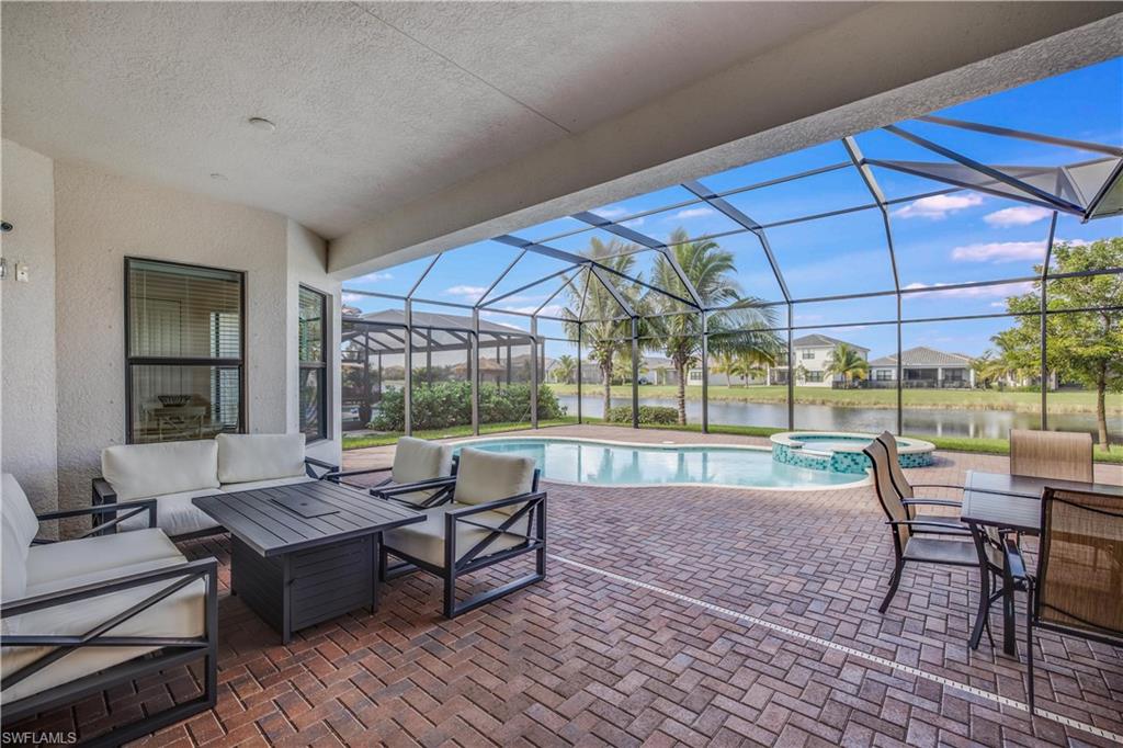 4549 Azalea Drive Naples, FL 34119 - Photo 5 of 25 a view of a patio with dining table and chairs