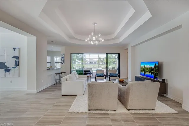 a living room with furniture and a chandelier