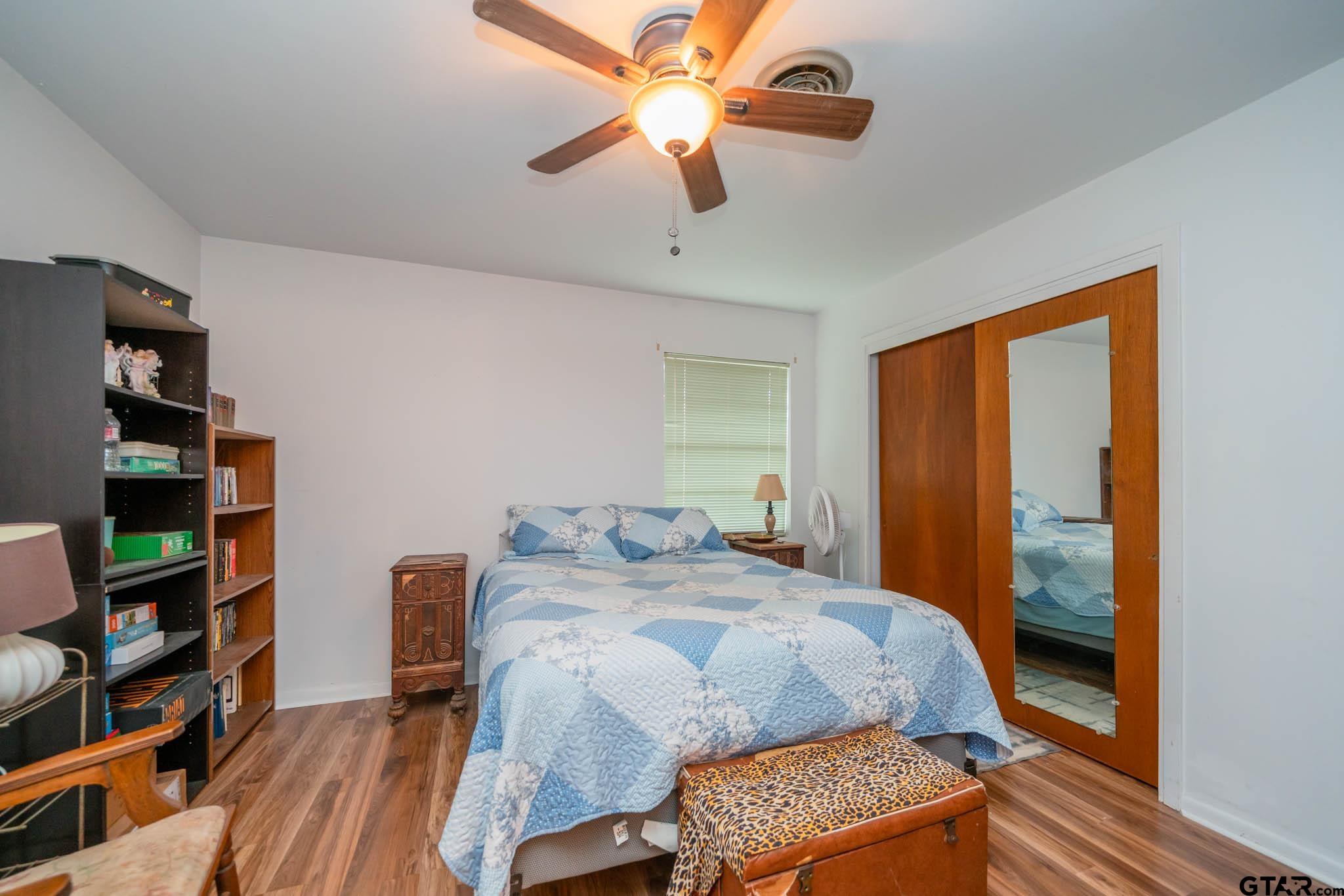 126 Jordan Street Rusk, TX 75785 - Photo 21 of 39 a bedroom with a bed furniture and a chandelier