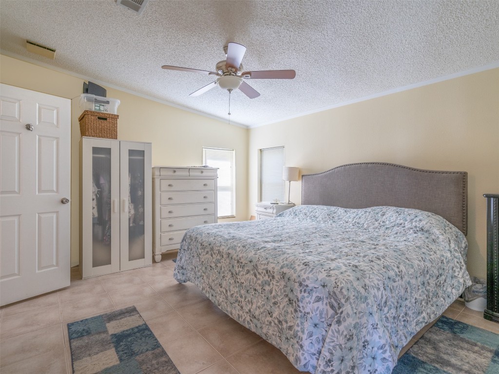 54598 Sheffield Road Callahan, FL 32011 - Photo 18 of 36 a bedroom with a bed and a chandelier