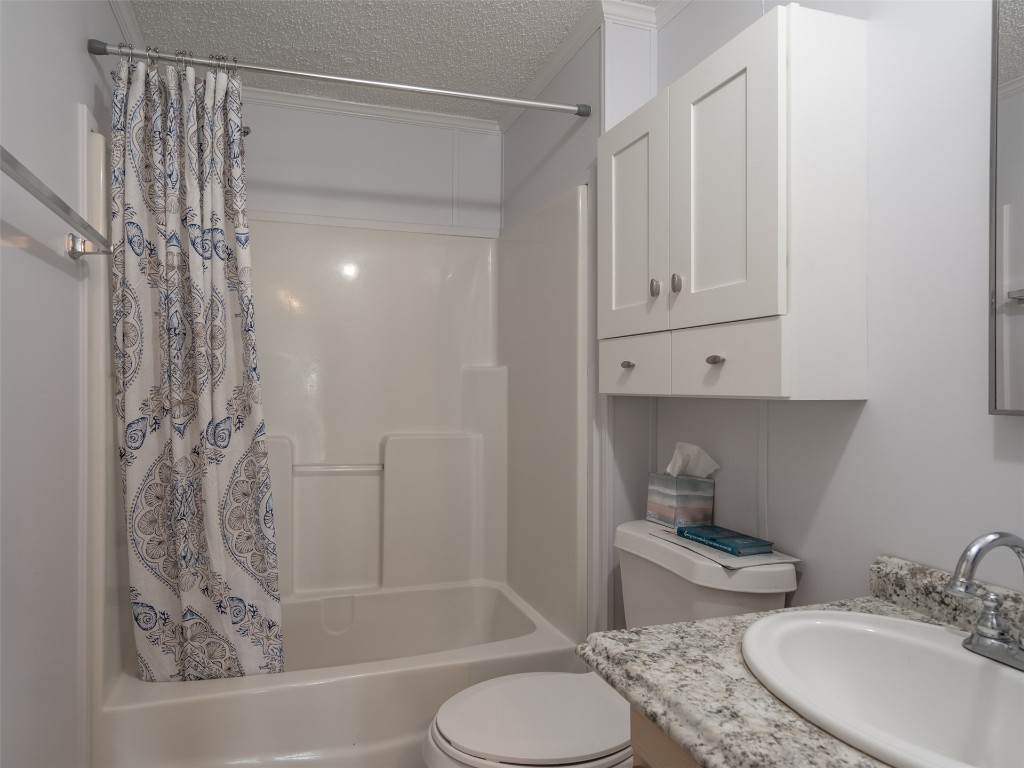 54598 Sheffield Road Callahan, FL 32011 - Photo 23 of 36 a bathroom with a granite countertop sink toilet and shower