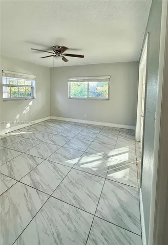 an empty room with windows and closet