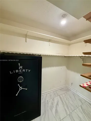 a view of hallway with window and a ceiling fan