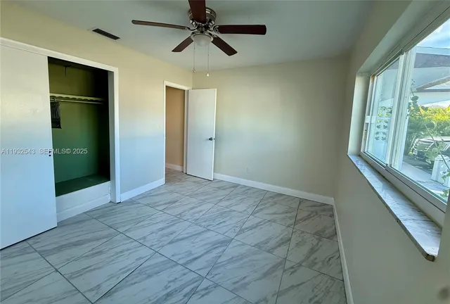 a view of an empty room with a window