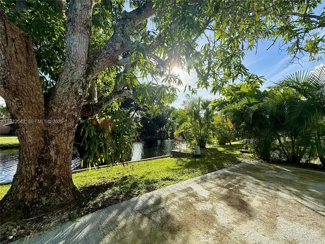 a view of a swimming pool with a yard