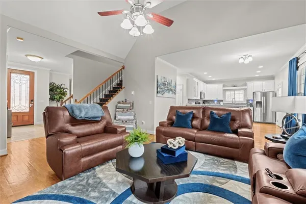 a bedroom with a bed couch and a large window