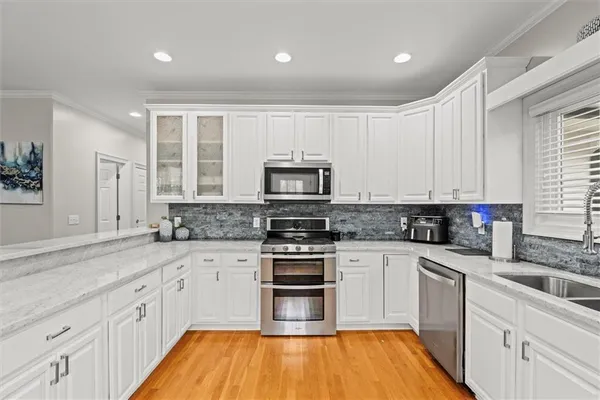 a bedroom with a bed couch and a large window
