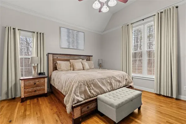 a bedroom with a bed and wooden floor