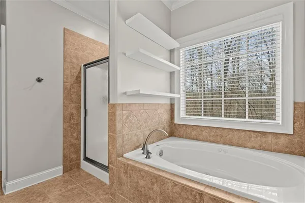 a bedroom with bed and a window