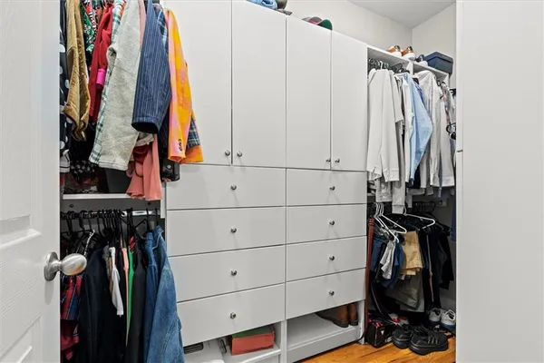 a bedroom with a bed and large windows