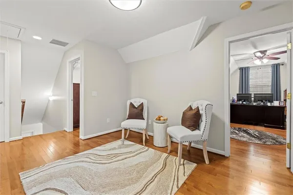 a bedroom with a bed and a potted plant