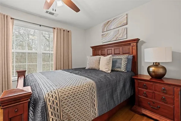 a bedroom with a large bed and a chandelier