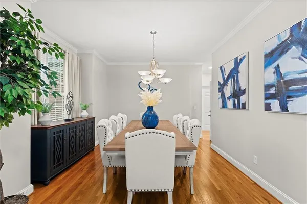 a dining room with furniture and a chandelier