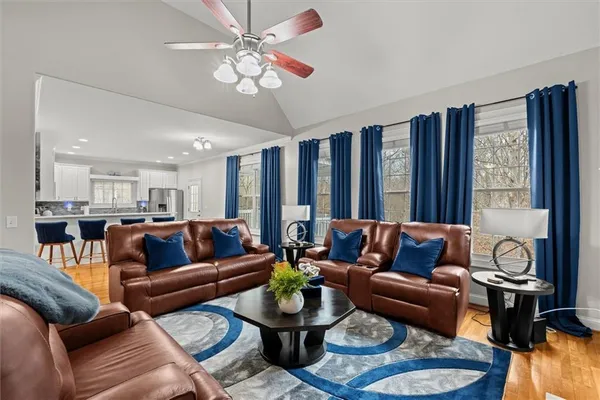 a living room with furniture kitchen and a chandelier