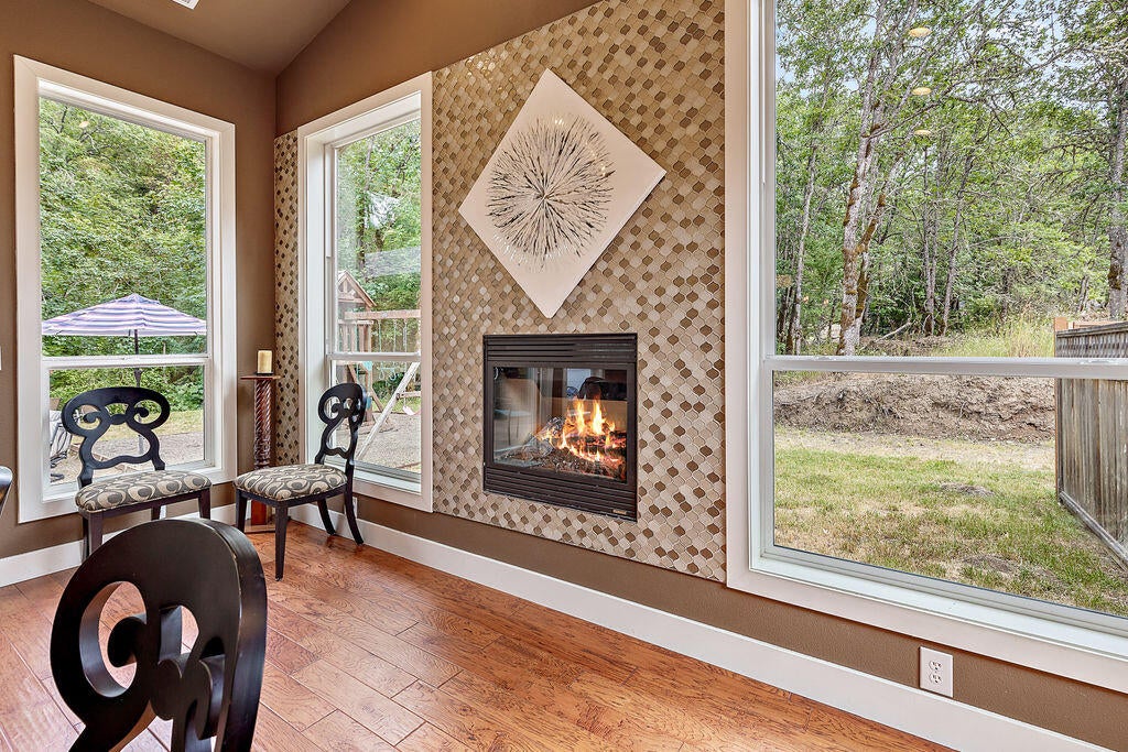 3653 Kane Creek Road Central Point, OR 97502 - Photo 9 of 29 Stylish Fireplace Accents the Dining Room