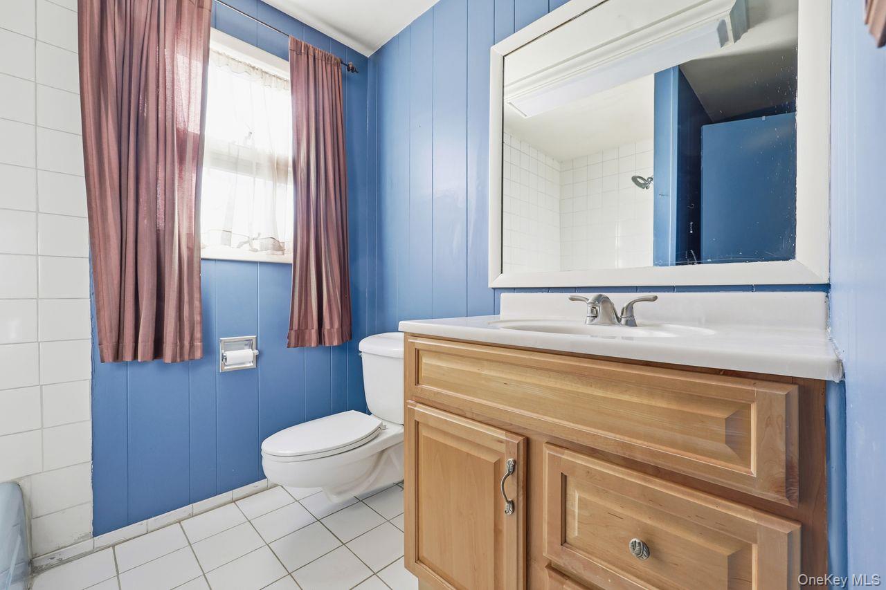 12 Sebago Road Carmel, NY 10512 - Photo 12 of 39 a bathroom with a sink a toilet and a mirror