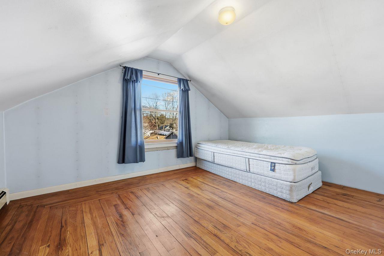 12 Sebago Road Carmel, NY 10512 - Photo 20 of 39 a view of an empty room with wooden floor and a window