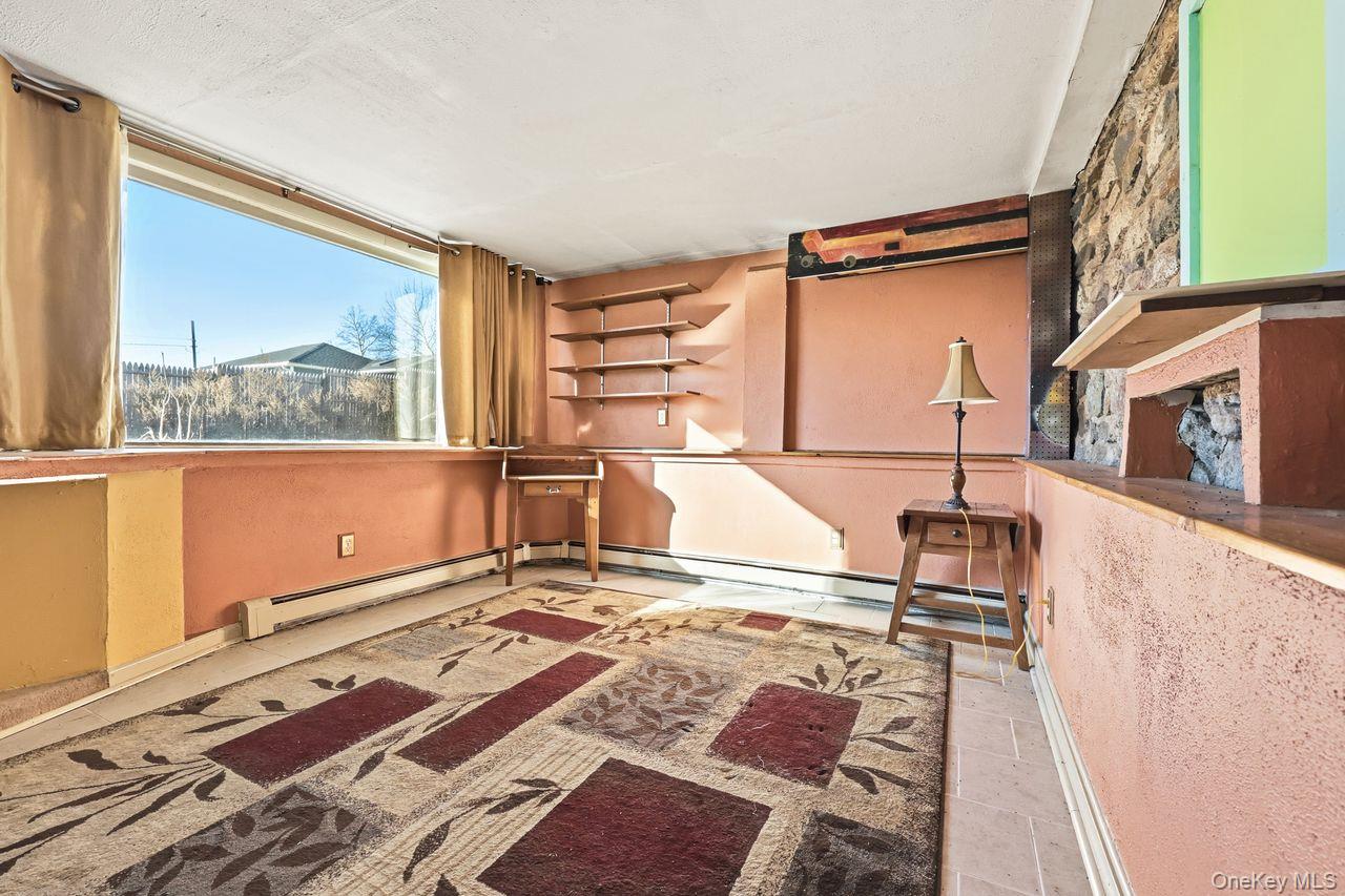 12 Sebago Road Carmel, NY 10512 - Photo 27 of 39 a living room with a bed and a rug