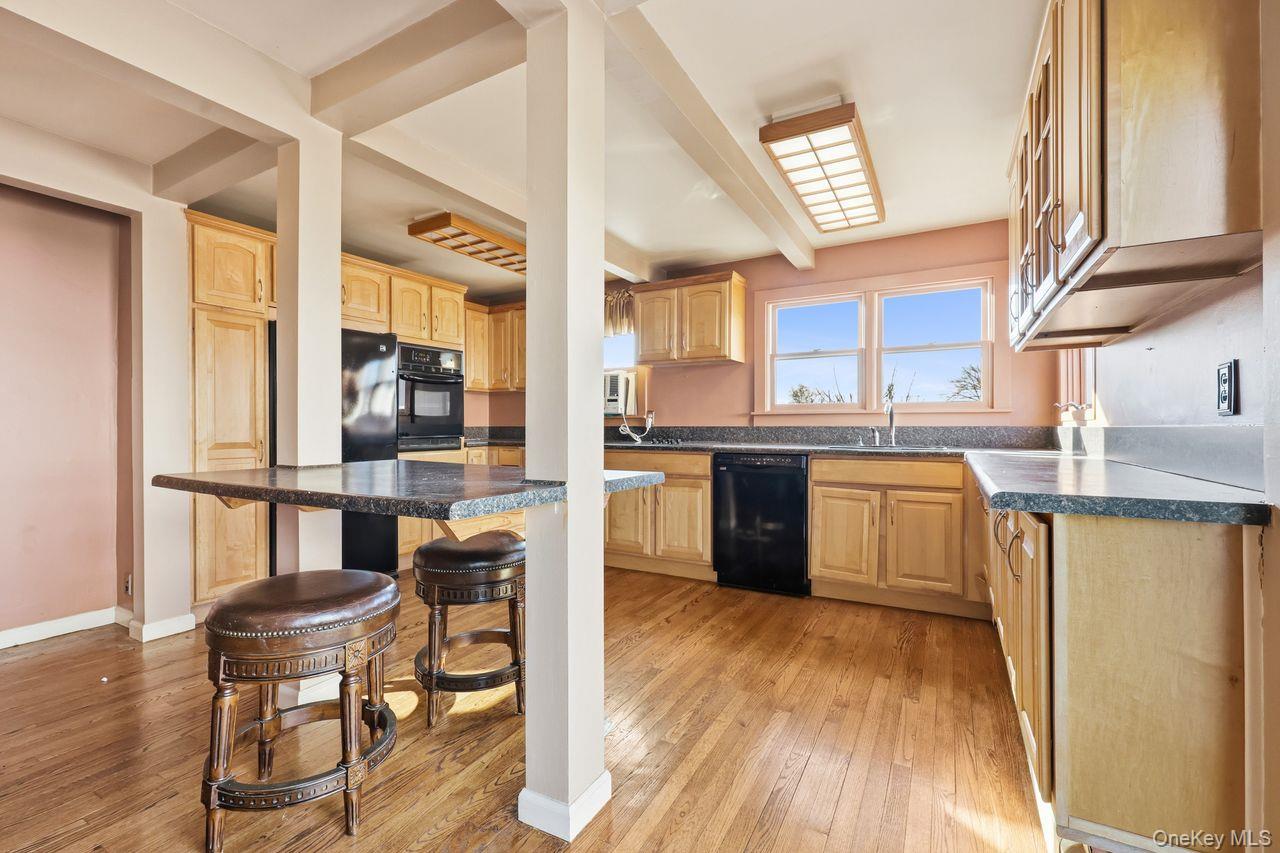 12 Sebago Road Carmel, NY 10512 - Photo 6 of 39 a kitchen with a table chairs refrigerator and cabinets
