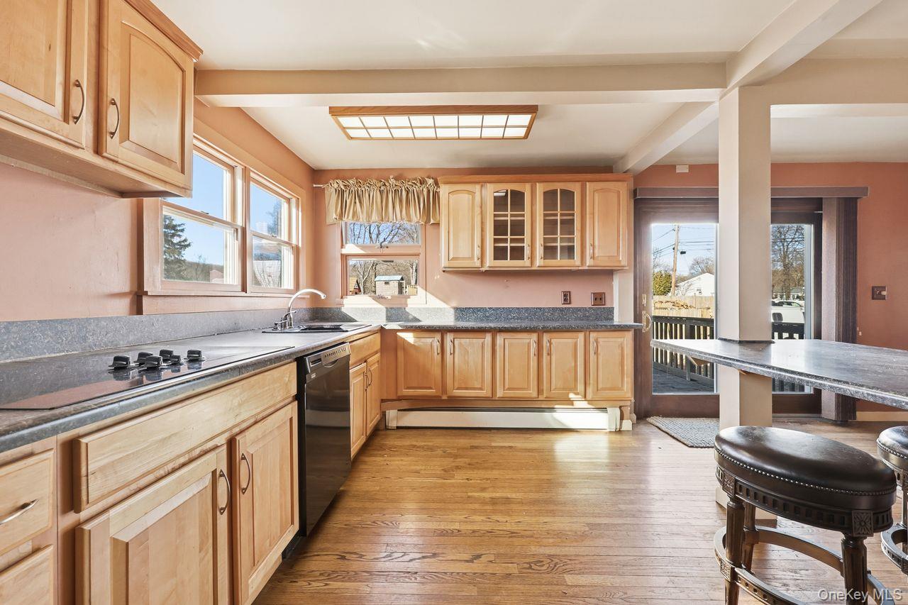 12 Sebago Road Carmel, NY 10512 - Photo 7 of 39 a kitchen with wooden cabinets and sink