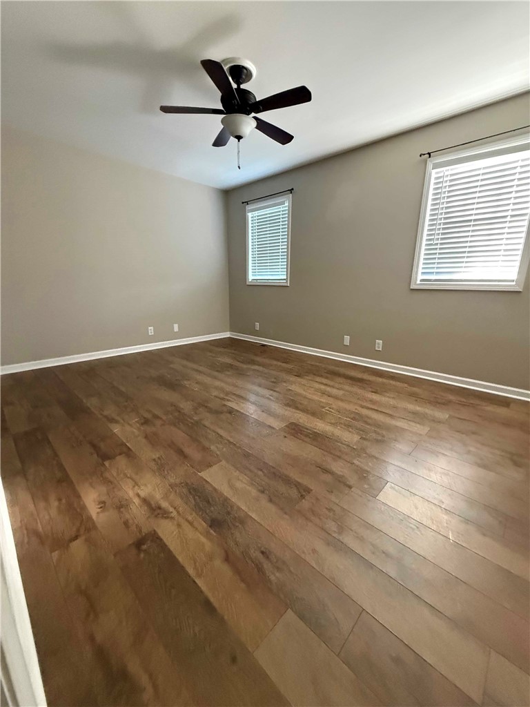 116 Kelly Lane Easley, SC 29642 - Photo 8 of 39 Warm wood flooring and clean baseboards anchor this versatile primary bedroom space.