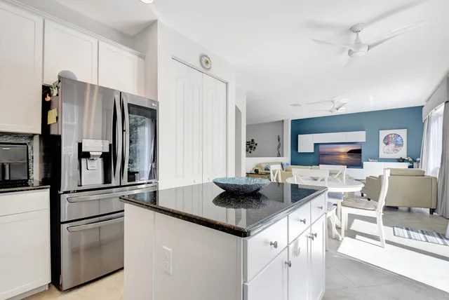 a kitchen with stainless steel appliances granite countertop a refrigerator and a stove top oven