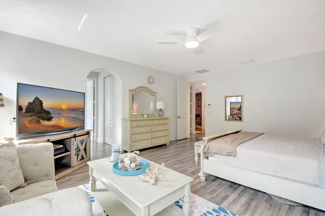 a bedroom with a bed a couch and dresser