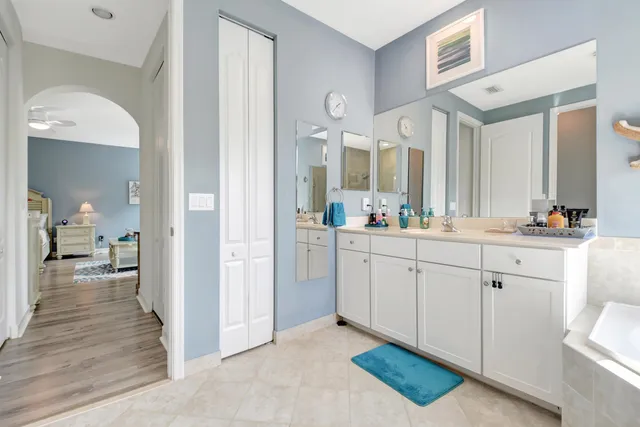 a spacious bathroom with a double vanity sink and a mirror