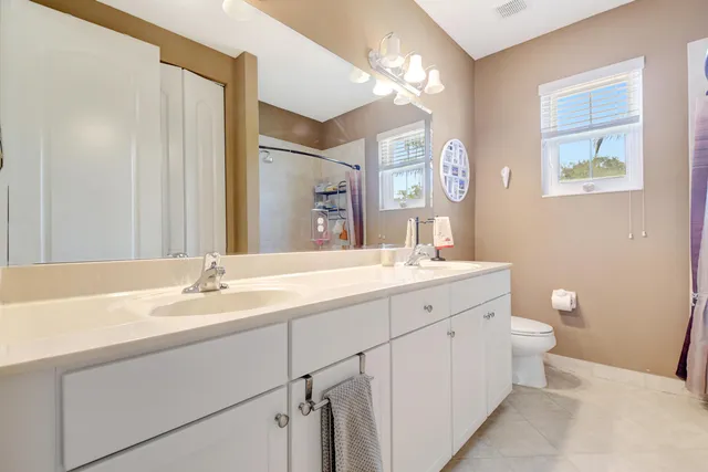 a bathroom with a double vanity sink and a mirror