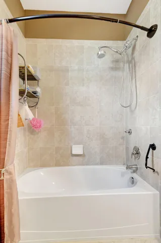 a bathroom with a shower and a bath tub