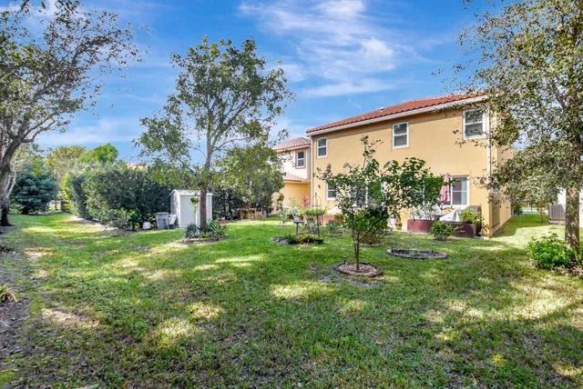 a view of a house with a yard and tree s