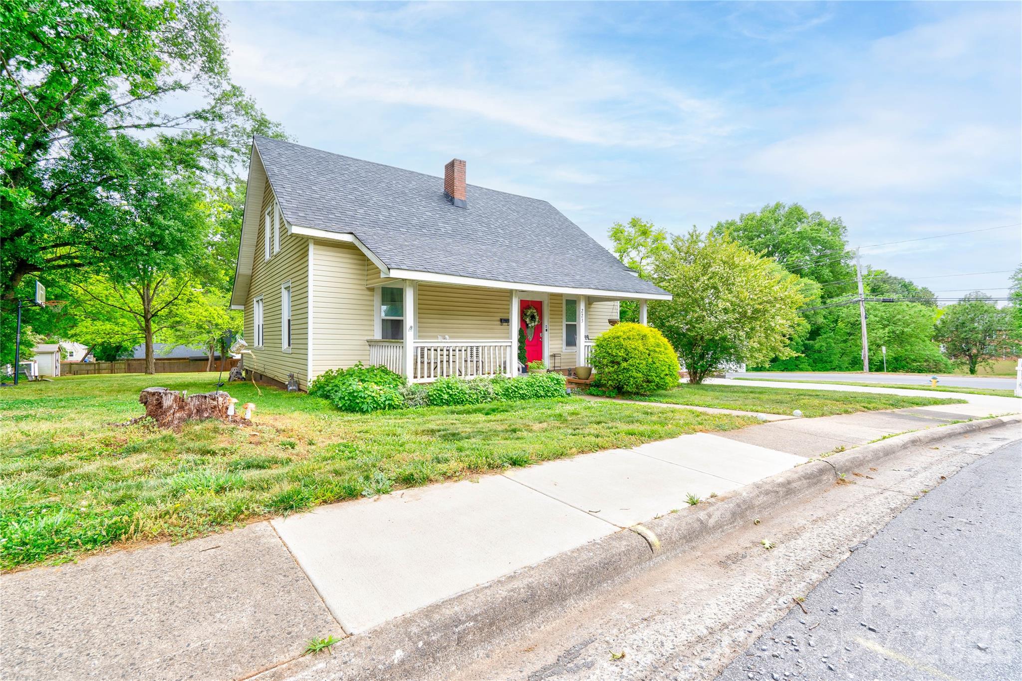 a house with green field in front of it