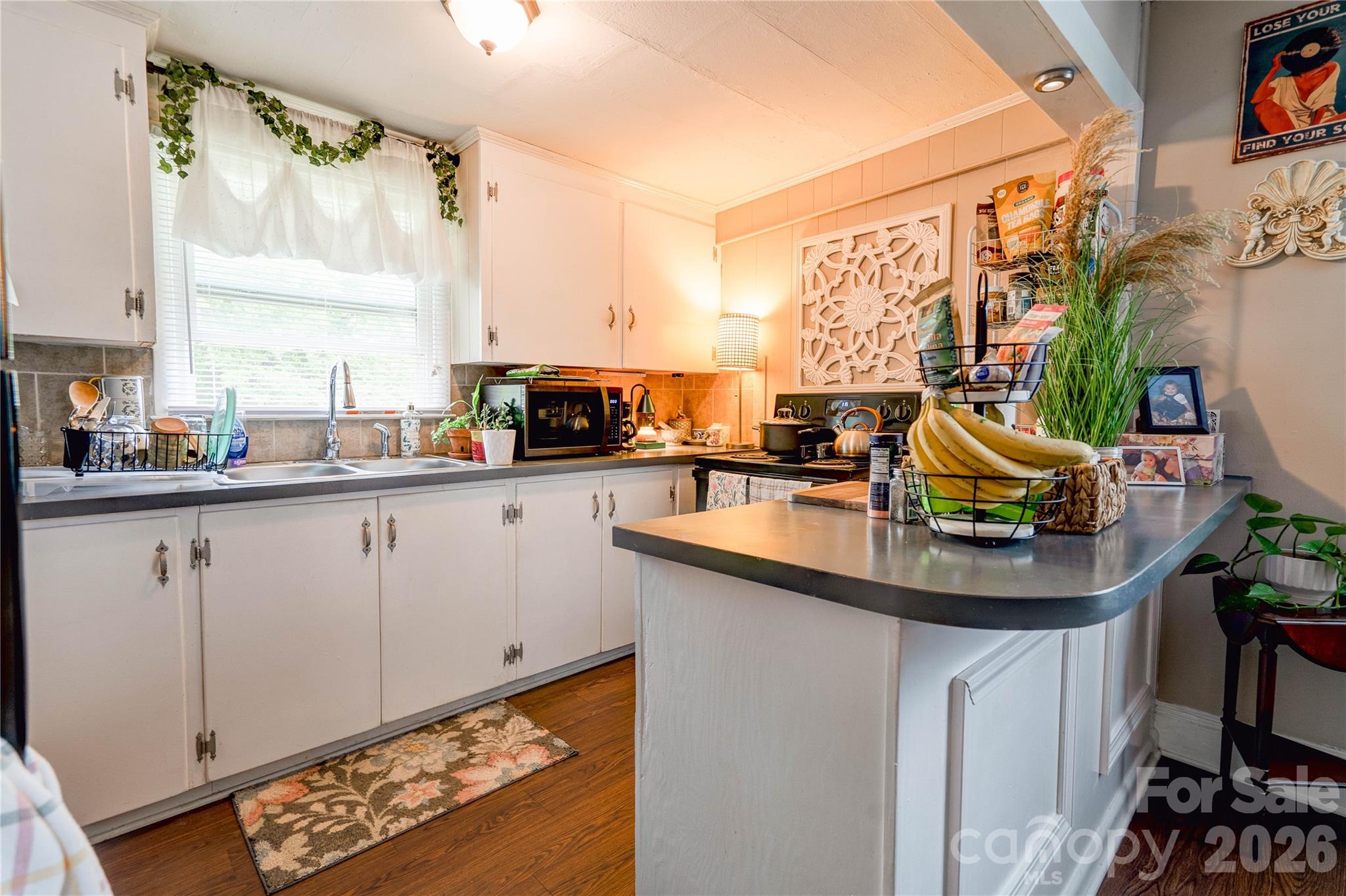 223 Waco Road Kings Mountain, NC 28086 - Photo 6 of 22 a kitchen with white cabinets a sink and a stove