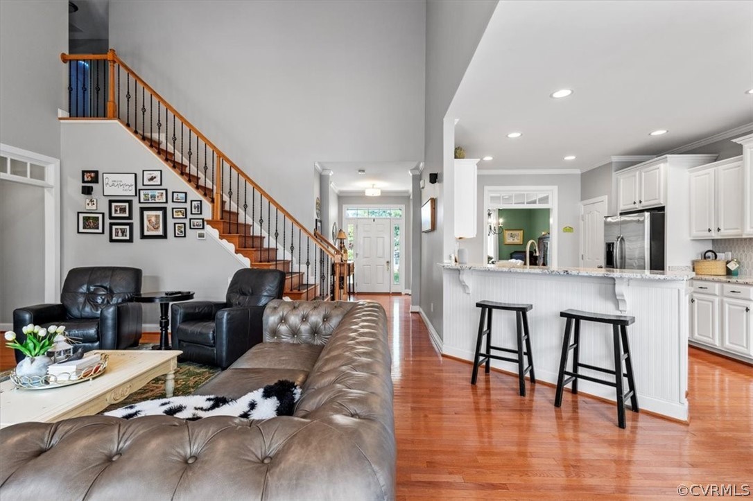 14701 Yarcombe Road Midlothian, VA 23112 - Photo 16 of 44 a living room with furniture and a dining table with wooden floor