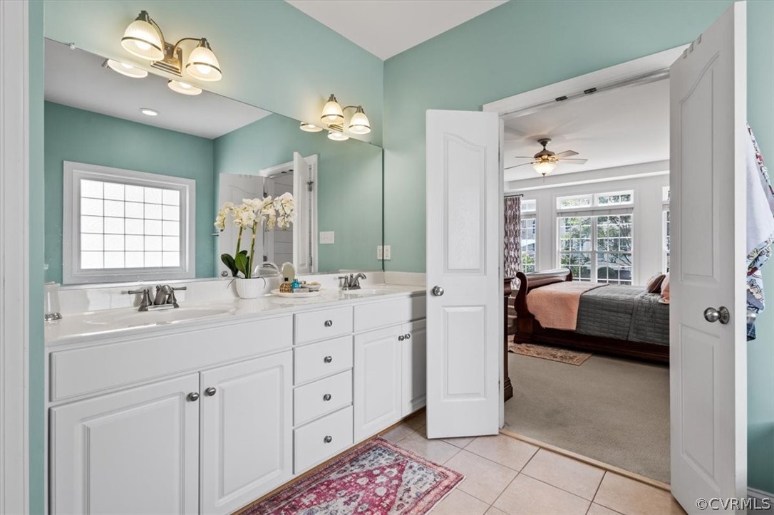 14701 Yarcombe Road Midlothian, VA 23112 - Photo 25 of 44 a en suite bathroom with double vanity a sink a large mirror a vanity and a window