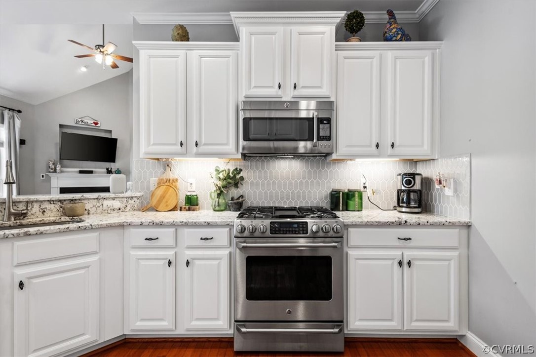 14701 Yarcombe Road Midlothian, VA 23112 - Photo 10 of 44 a kitchen with white cabinets and appliances