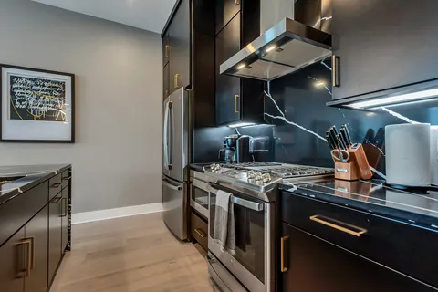 a stove top oven sitting inside of a kitchen