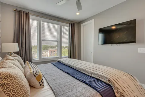 a bedroom with a large bed and a flat screen tv