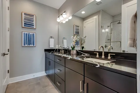 a bathroom with double sink and a mirror