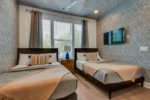 a bedroom with bed and a flat screen tv