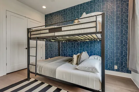 a bedroom with 2 bed and a window