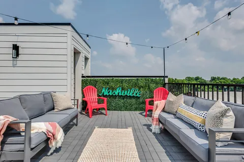 a balcony with couch and outdoor view
