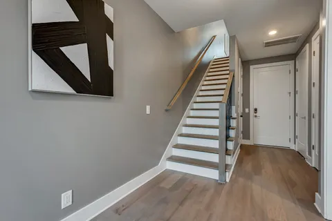 a view of an entryway with wooden floor