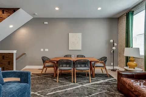 a dining room with furniture and window