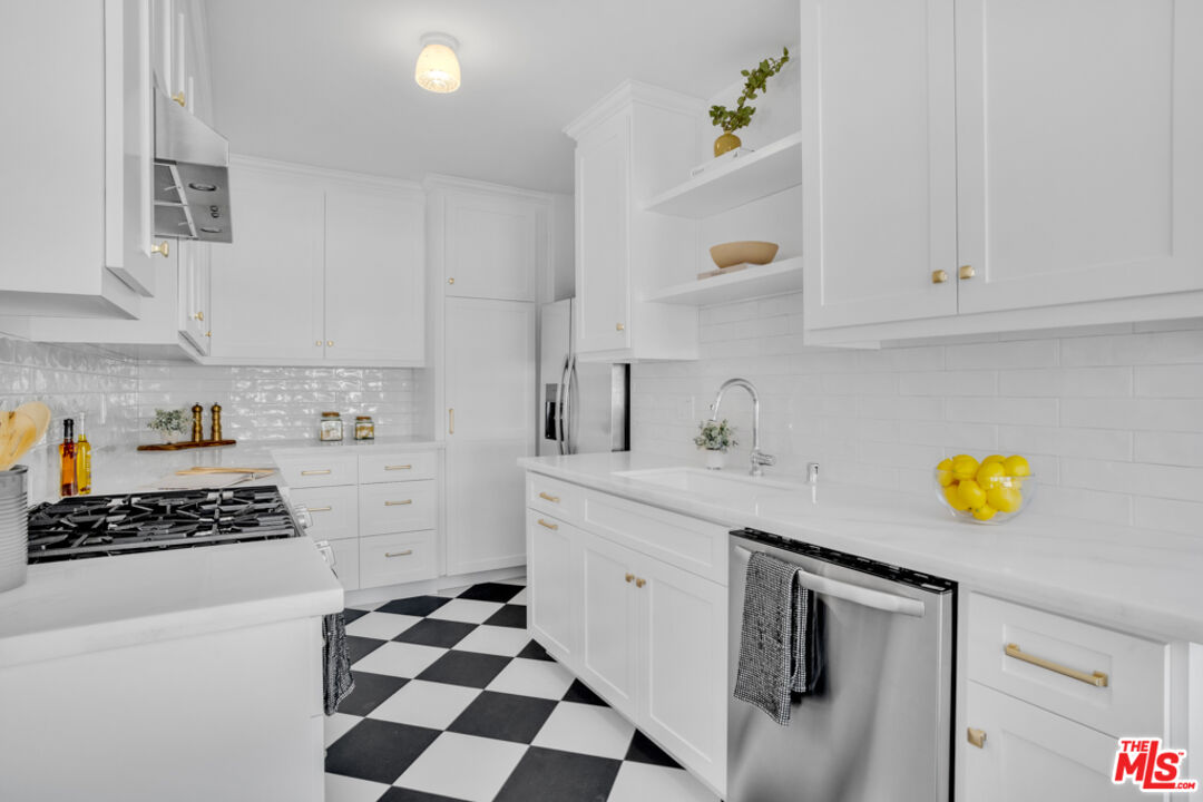 1901 Montecito Drive Glendale, CA 91208 - Photo 17 of 64 a kitchen with stainless steel appliances a sink a stove and a refrigerator
