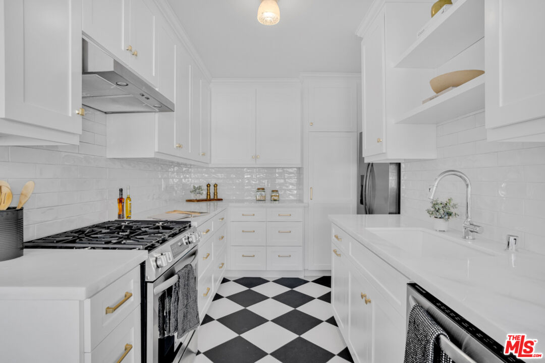1901 Montecito Drive Glendale, CA 91208 - Photo 18 of 64 a kitchen with stainless steel appliances a stove a sink and a refrigerator