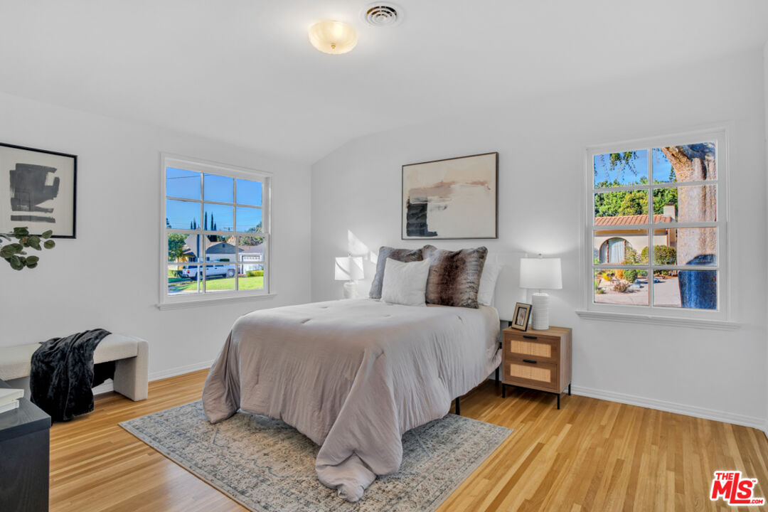 1901 Montecito Drive Glendale, CA 91208 - Photo 26 of 64 a bedroom with a bed and wooden floor