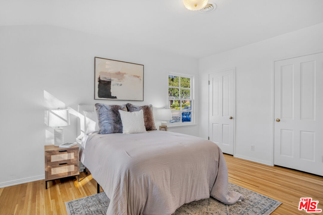 1901 Montecito Drive Glendale, CA 91208 - Photo 27 of 64 a bedroom with a bed and wooden floor